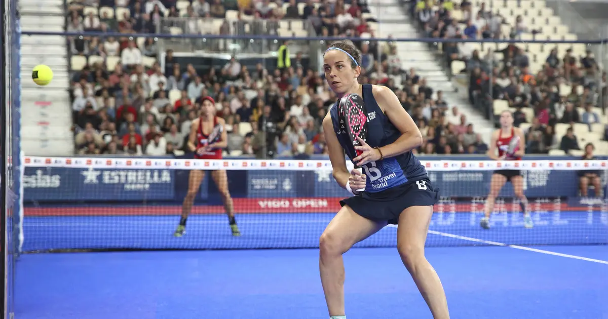 A padel player hitting a chiquita at the net — a low, controlled passing shot